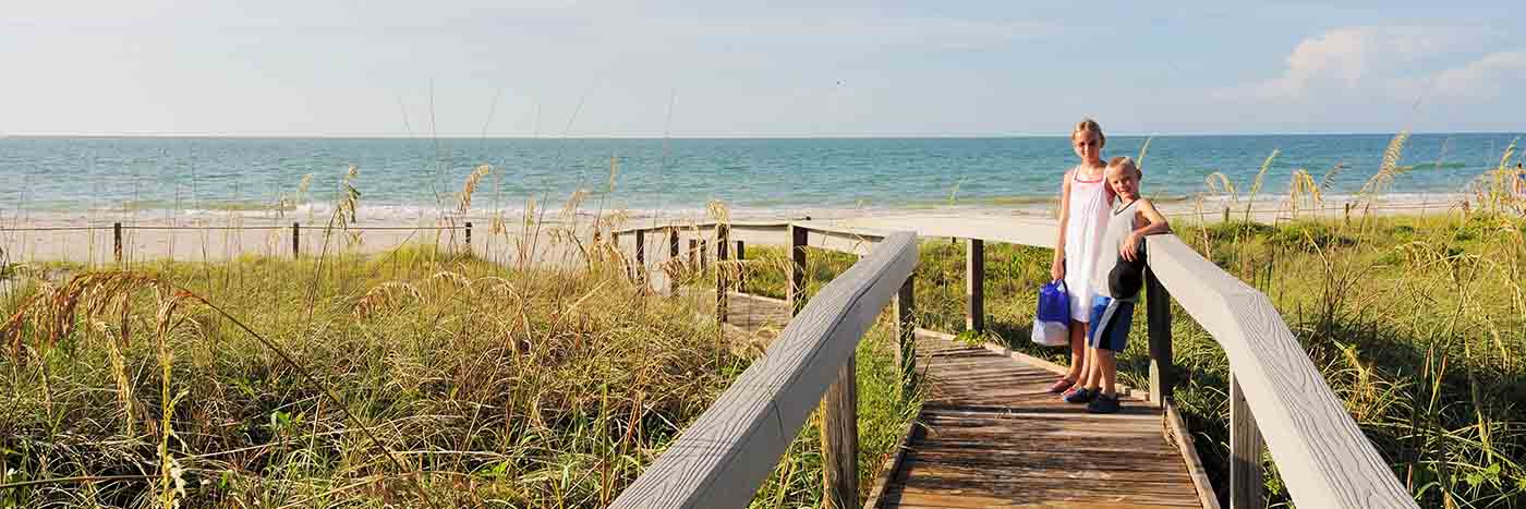 Kids on bridge to beach at Sanibel Island