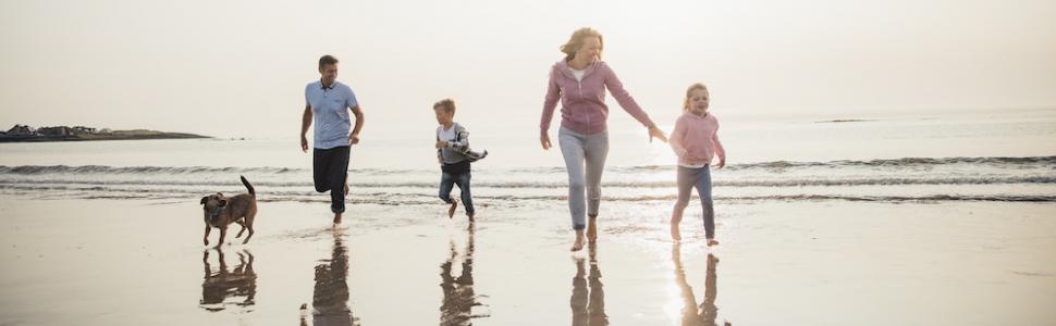 family on beach with dog